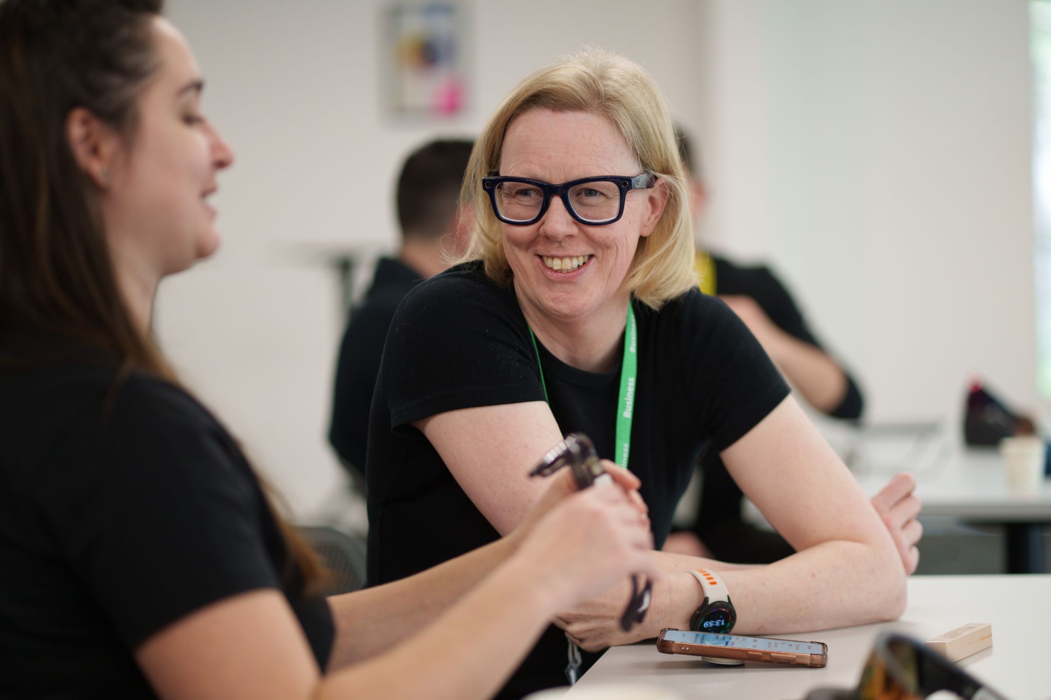 Hilary from Vision Ireland smiling and chatting with a colleague while wearing Meta Ray-Ban smart glasses.